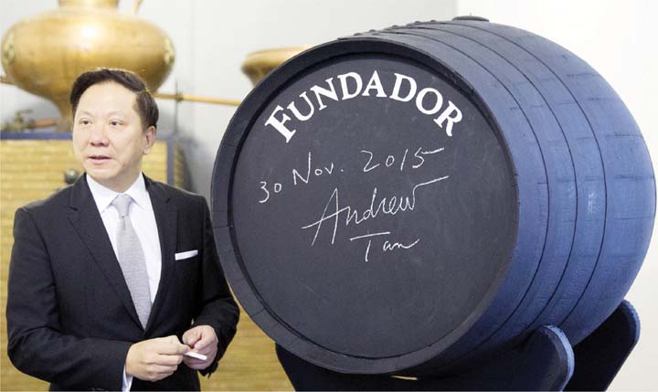 Emperador Inc. chairman Andrew L. Tan signs the Fundador barrel during a visit at the Bodegas Fundador in Jerez Spain yesterday following his company's acquisition of the Spanish iconic brandy