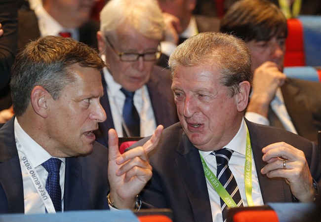 England soccer team coach Roy Hodgson right chats with another guest after arriving for the Euro 2016 soccer championships draw in Paris Saturday Dec. 12 2015