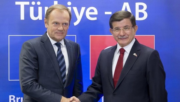 European Commission President Donald Tusk and Prime Minister Ahmet Davutoglu shake hands at the EU-Turkey summit in Brussels Nov. 29 2015