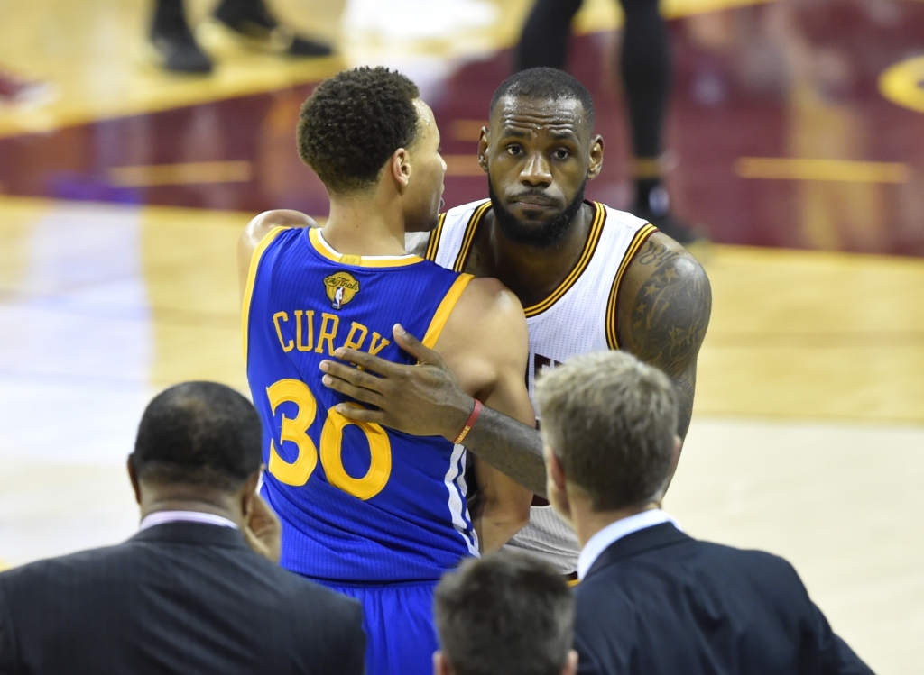 Jun 16 2015 Cleveland OH USA Cleveland Cavaliers forward Le Bron James shakes hands with Golden State Warriors guard Stephen Curry during the fourth quarter of game six of the NBA Finals at Quicken Loans Arena. Warriors won 105-97. Mandatory