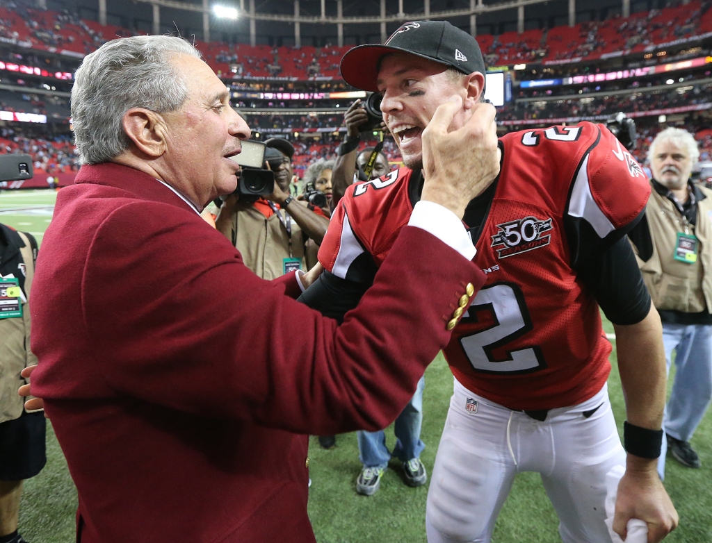 Falcons owner Arthur Blank and quarterback Matt Ryan celebrate ending Carolina's perfect season with a 20-13 victory at the Georgia Dome