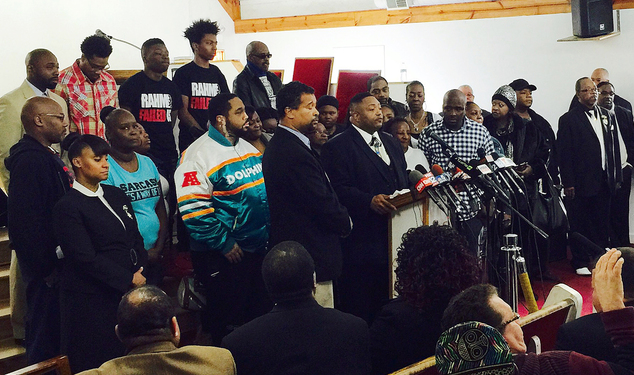 The Rev. Marvin Hunter center the great uncle of Laquan McDonald accompanied by other family members and supporters speaks at a news conference Friday D