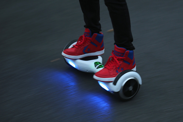 KNUTSFORD ENGLAND- OCTOBER 13 A youth poses as he rides a hoverboard which are also known as self-balancing scooters and balance boards