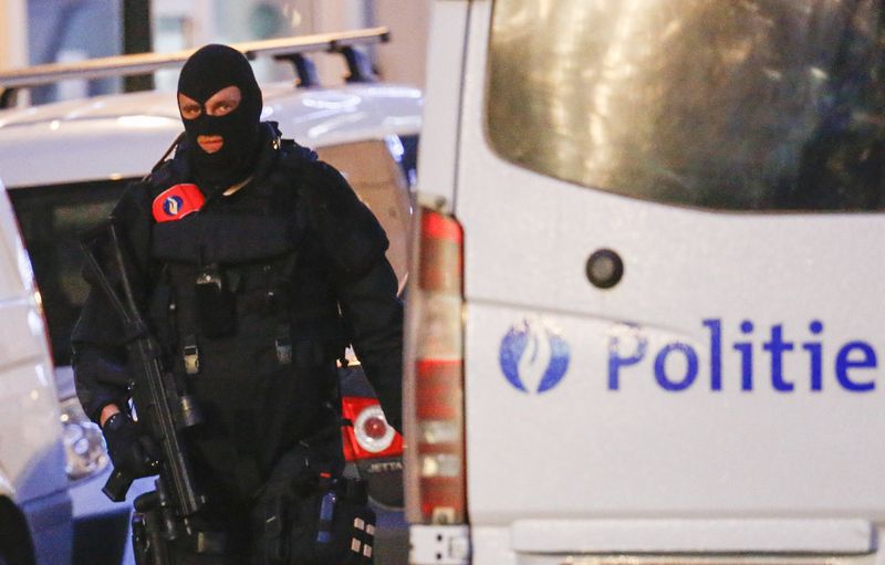 A Belgian special forces police officer patrols a street during a police raid in central Brussels Belgium in connection with last month's deadly Paris attack. – Reuters pic