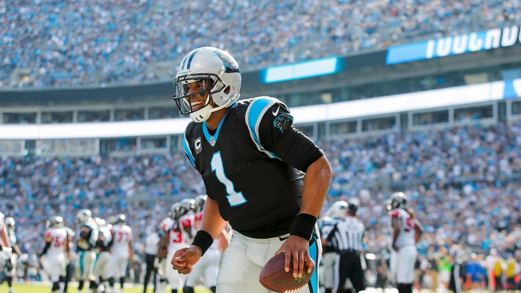 Carolina Panthers quarterback Cam Newton smiles as he celebrates a touchdown against the Atlanta Falcons during an NFL football game at Bank of America Stadium in Charlotte