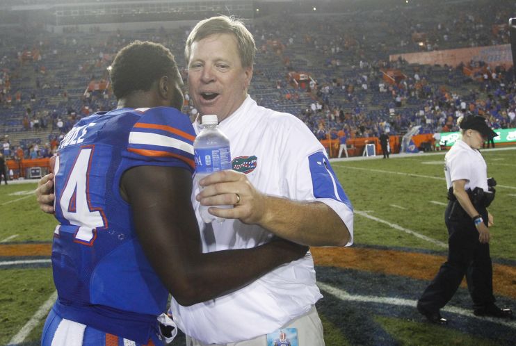 Florida Gators head coach Jim Mc Elwain hugs defensive back Brian Poole after a 61-13 win over New Mexico State