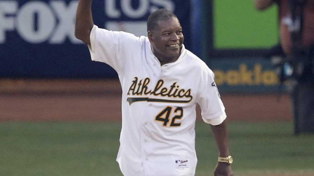 Former Oakland Athletics player Dave Henderson waves before throwing out the ceremonial first pitc in Oakland Calif. Friday Oct. 4 2013