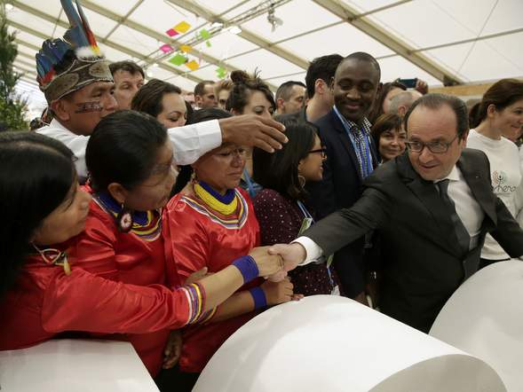 French President Francois Hollande shakes hands with Ecuadorians in the Climate Generations area during the World Climate Change Conference 2015 at Le Bourget