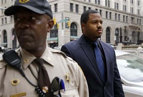 Officer William Porter right one of six Baltimore city police officers charged in connection to the death of Freddie Gray walks into a courthouse during jury deliberations Wednesday Dec. 16 2015 in Baltimore. Jurors failed to reach a verdict in the