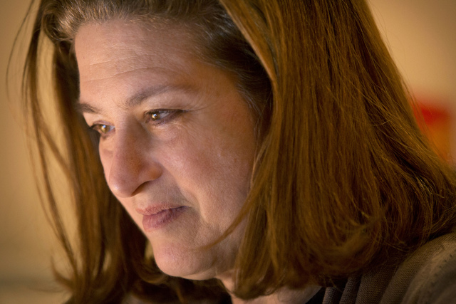 ASSOCIATED PRESS           French journalist Ursula Gauthier a reporter for the French news magazine L’Obs looks at her laptop computer in her apartment in Beijing Saturday Dec. 26 2015. China said Saturday it will not renew