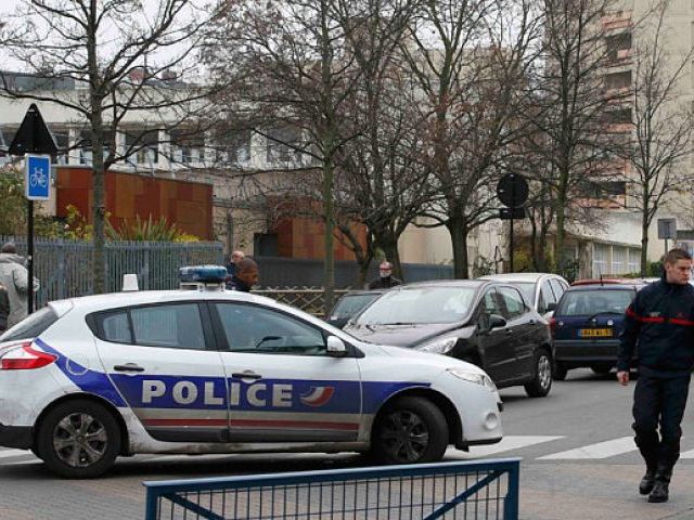 French police are seen in front of the nursery school where a hooded man claiming to be acting for Islamic State attacked a teacher