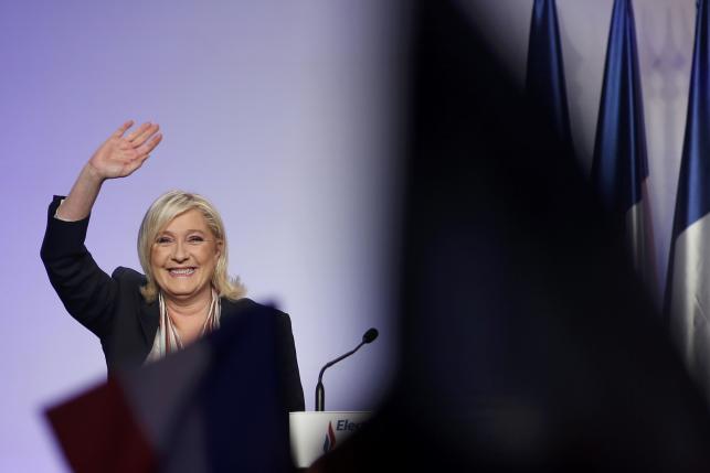 Marine Le Pen French National Front political party leader and candidate for the National Front in the Nord-Pas-de-Calais-Picardie region arrives to attend a political rally as she campaigns for the upcoming regional elections in Paris France December