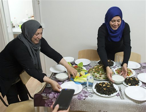 10 2015 Syrian refugees Reem Habashieh right and her mother Khawla Kareem left prepare dinner in their flat in Zwickau eastern Germany. Three months after their arrival in Germany and after being bounced around fro