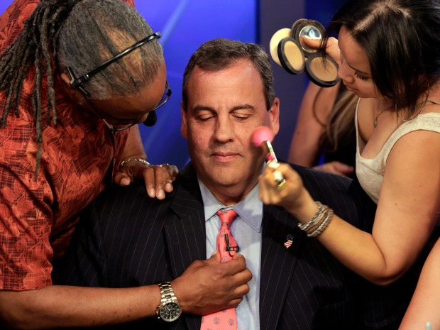 Republican presidential candidate New Jersey Gov. Chris Christie gets his microphone and make-up prepared for his appearance on'The Five television program