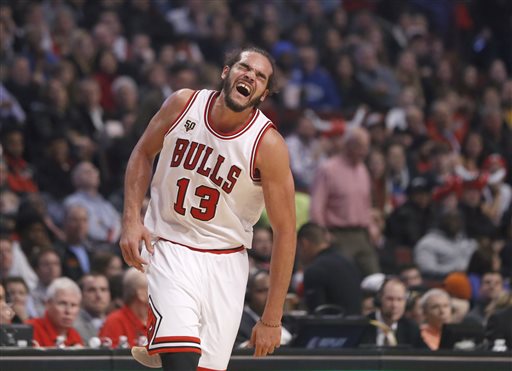 Chicago Bulls center Joakim Noah runs down the court with an apparent injury to his left shoulder during the second half of an NBA basketball game against the Brooklyn Nets on Monday Dec. 21 2015 in Chicago. The Nets won 105-102. AP