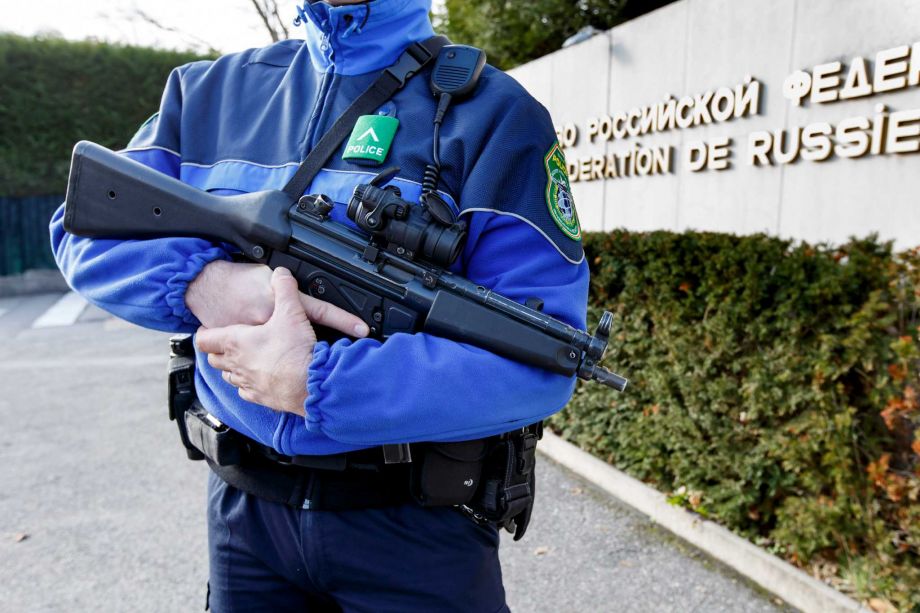 A Swiss police officer controls the area in front of the Russian mission in Geneva Switzerland Thursday Dec. 10 2015. Geneva police were'actively searching for suspects in connection with an investigation into the Paris attacks last month Swiss sec