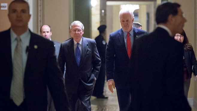 Senate Majority Leader Mitch McConnell R-Ky. left and Majority Whip John Cornyn R-Texas right return to the chamber during a marathon series of rapid votes on bills and amendments known on Capitol Hill as a'vote-a-rama' in Washington Thursday nig