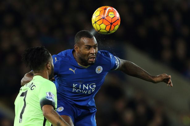 Wes Morgan of Leicester City clears from Raheem Sterling of Manchester City