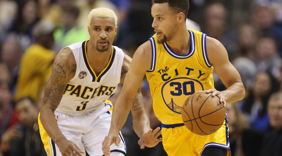 Golden State Warriors guard Stephen Curry is guarded by Indiana Pacers guard George Hill at Bankers Life Fieldhouse