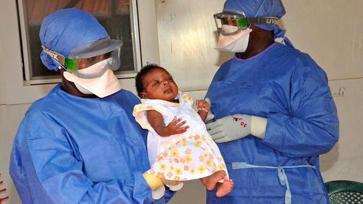 Medical workers present Noubia the last known patient to contract Ebola in Guinea during her release from a Doctors Without Borders treatment center in Conakry