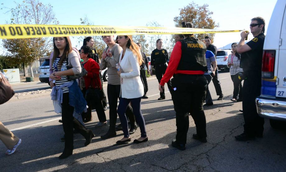 Survivors are evacuated from the scene of a shooting under police and sheriff's escort on Wednesday in San Bernardino Calif. The latest shooting is one of too many in United States this year. The status quo is unacceptable and it is time have serious