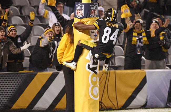 Pittsburgh Steelers wide receiver Antonio Brown leaps on the goal post after scoring a touchdown during the second half of an NFL football game against the Indianapolis Colts Sunday Dec. 6 2015 in Pittsburgh. The Steelers won 45-10. (AP