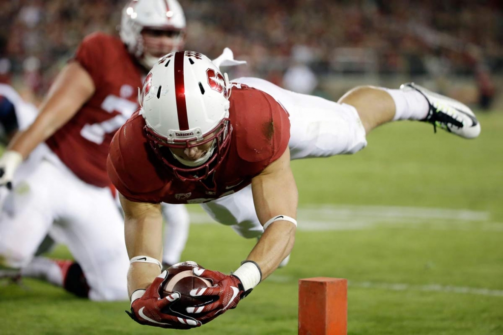 Mc Caffrey lunging into the end zone for a touchdown against Arizona during the first half of an NCAA college football game in Stanford California