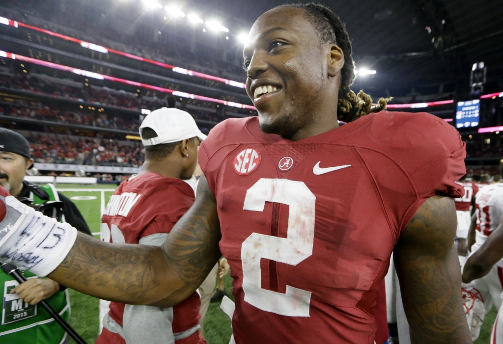 Alabama running back Derrick Henry greets Wisconsin players after an NCAA college football game Saturday Sept. 5 2015 in Arlington Texas. Henry rushed for 147 yards with three touchdowns and No. 3 Alabama ran away with a 35-17 victory over No. 20