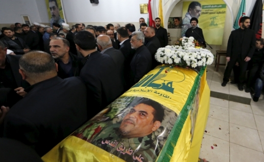 People offer their condolences near the coffin of Lebanese Hezbollah militant leader Samir Kuntar during his funeral in Beirut's southern suburbs Leban