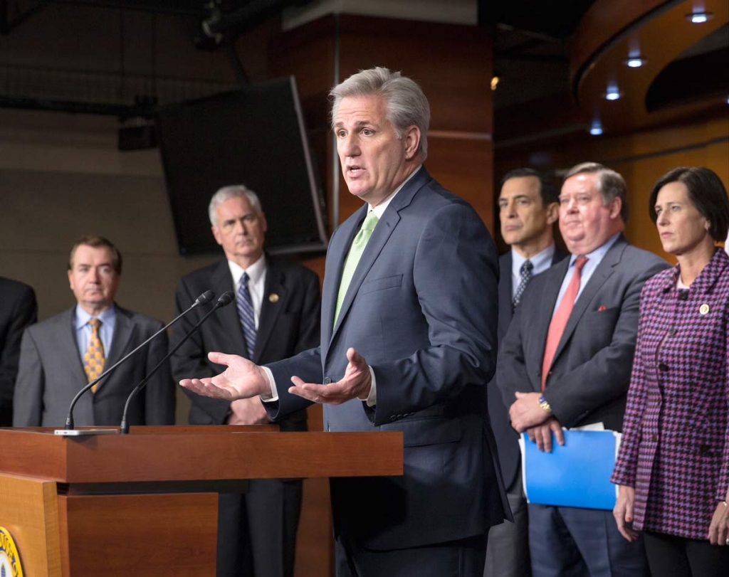 House Majority Leader Kevin Mc Carthy of Calif. center answers questions from reporters about ongoing negotiations to finalize a $1.1 trillion government-wide spending bill and a sprawling tax package Friday Dec. 11 2015 during a news conference on C