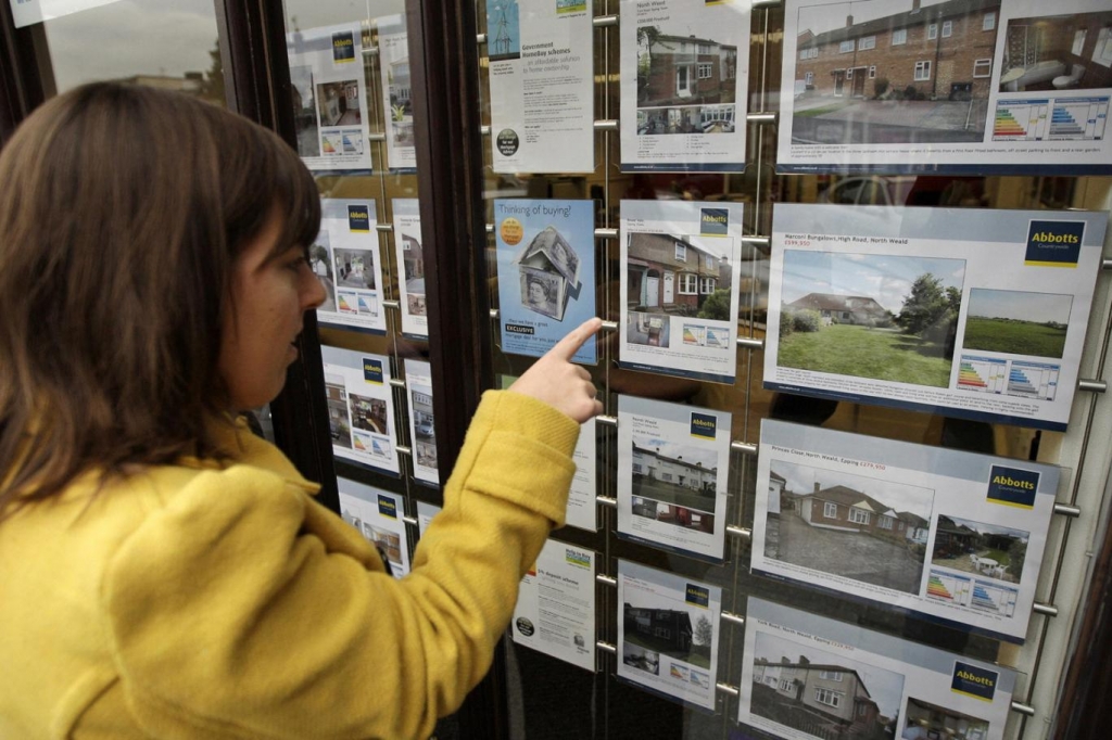 House buyer browsing at estate agent's window