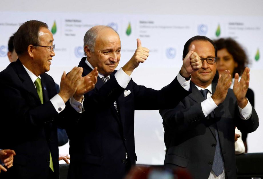 French foreign minister and President of the COP21 Laurent Fabius center applauds while United Nations Secretary General Ban Ki-moon left and French President Francois Hiollande applaud after the final conference of the COP21 the United Nations confe