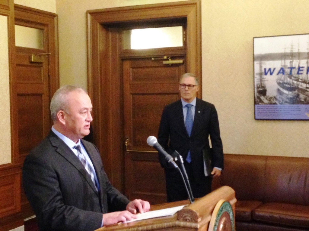 Washington Corrections Secretary Dan Pacholke addresses reporters as Gov. Jay Inslee looks on during a news conference to announce the accidental early release of 3,200 inmates over a 13 year period