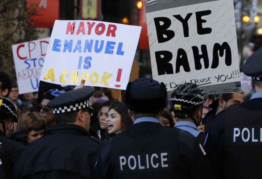 Protesters engage Chicago police officers during a march calling for Chicago Mayor Rahm Emanuel and Cook County State's Attorney Anita Alvarez to resign in the wake of a police scandal Wednesday Dec. 9 2015 in Chicago