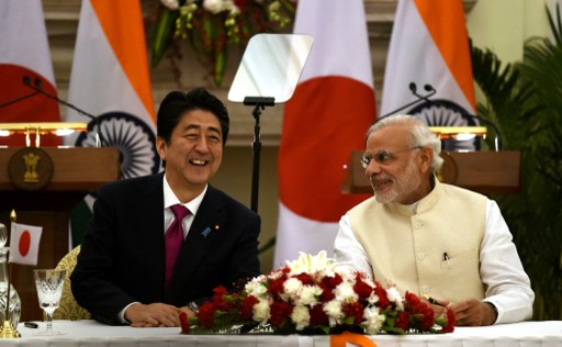 India's Prime Minister Narendra Modi shares a light moment with Japan's Prime Minister Shinzo Abe before the signing of agreements at Hyderabad House in New Delhi