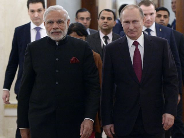 Russian President Vladimir Putin and India's Prime Minister Narendra Modi enter a hall during a meeting at the Kremlin in Moscow