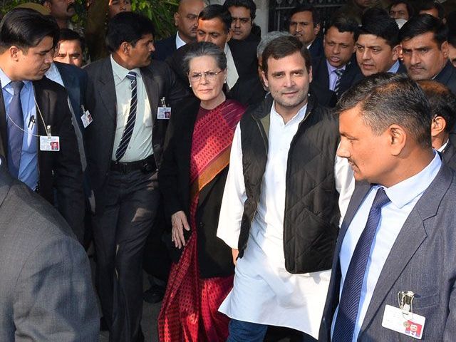 Vice-President of India's Congress Party Rahul Gandhi walks with his mother and party President Sonia Gandhi and officials as they leave Patiala House Court in New Delhi