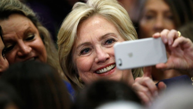 Democratic presidential candidate Hillary Rodham Clinton uses a supporter's mobile telephone to take