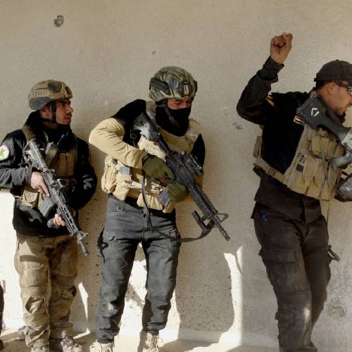 Iraqi security forces search a building in the government complex in central Ramadi 70 miles west of Baghdad Iraq. Iraqi military forces on Monday retook a strategic government complex in the