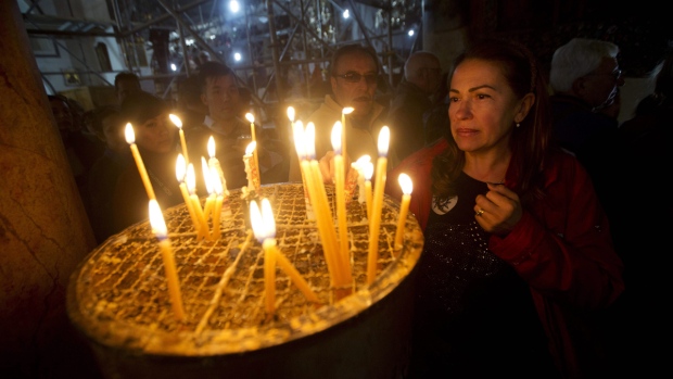 Lighting candles at the Church of the Nativity