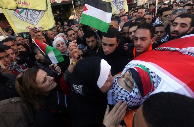 Relatives mourn as they carry the body of 56-year-old Palestnian Maher al-Jabi who died in the hospital from wounds sustained after Israeli soldiers shot at him as he reportedly rammed his car into a group of soldiers at an Israeli military checkpoint