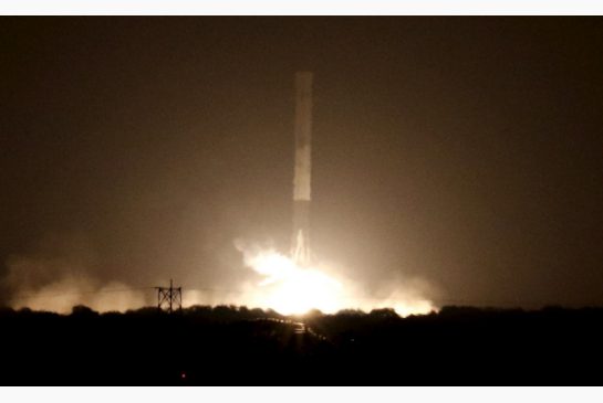 The first stage of the SpaceX Falcon 9 rocket returns to land at Cape Canaveral Air Force Station on Monday