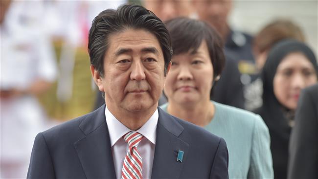 Japanese PM Shinzo Abe and his wife Akie Abe arrive to attend the 27th ASEAN Summit in Malaysia