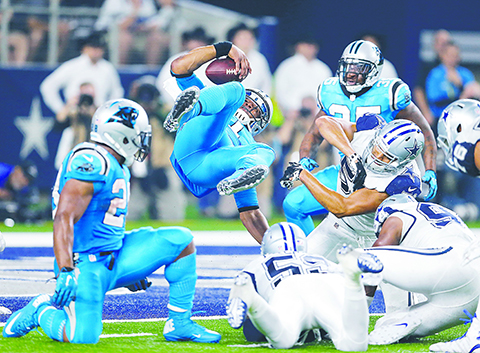 Carolina Panthers quarterback Cam Newton is upended and lands in the end zone at the end of a running play scoring a touchdown against the Dallas Cowboys during the second half of an NFL football game Thursday Nov. 26 2015 in Arlington Texas. (AP P