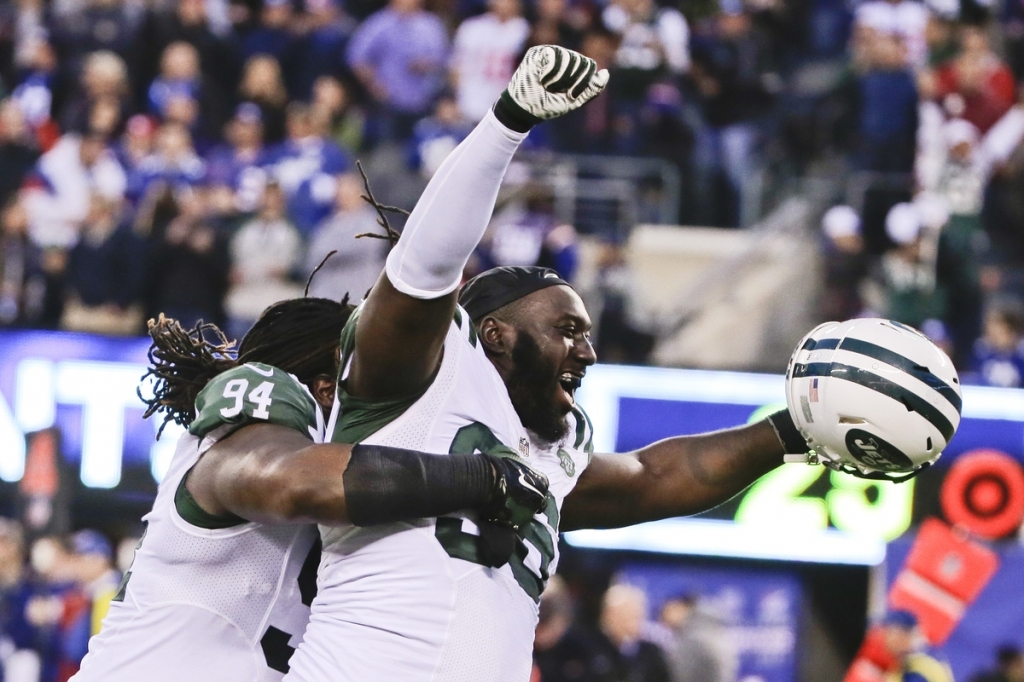 Muhammad Wilkerson and Damon Harrison of the Jets celebrate after beating the Giants 23-20 in overtime on Sunday at East Rutherford N.J