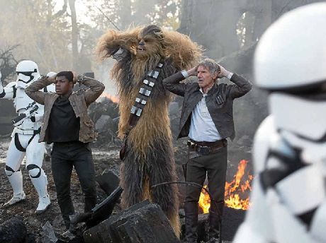 John Boyega Peter Mayhew and Harrison Ford in a scene from the movie Star Wars The Force Awakens