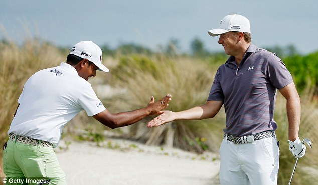 Jordan Spieth celebrates his hole-in-one on the second hole with Anirban Lahiri on Thursday