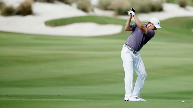 Jordan Spieth of the United States hits his second shot on the third hole