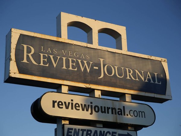 A sign for the Las Vegas Review Journal is seen Thursday Dec. 17 2015 in Las Vegas. The family of billionaire casino mogul and GOP kingmaker Sheldon Adelson confirmed in a statement to the Las Vegas Review Journal that they are the new owners of Nevada