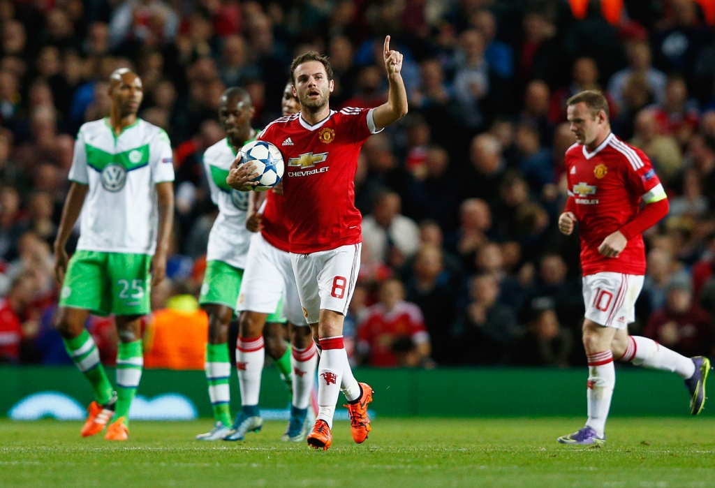 MANCHESTER ENGLAND- SEPTEMBER 30 Juan Mata of Manchester United celebrates as he scores their first and equalising goal from the penalty spot during the UEFA Champions League Group B match between Manchester United FC and VfL Wolfsburg at Old Traf